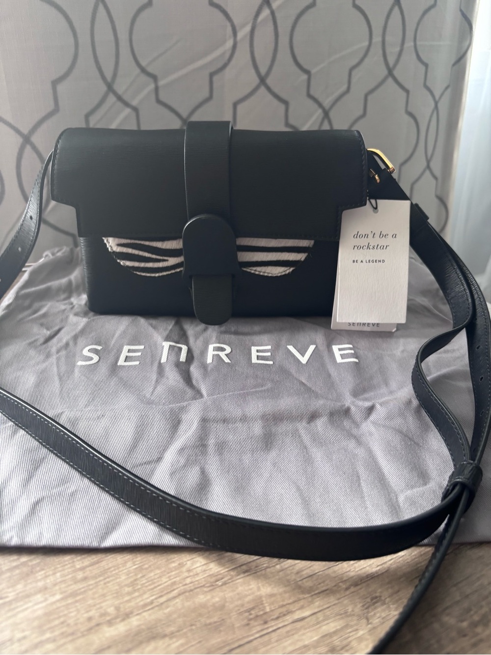 Senreve Aria Black Leather Crossbody Bag with zebra calf hair wing